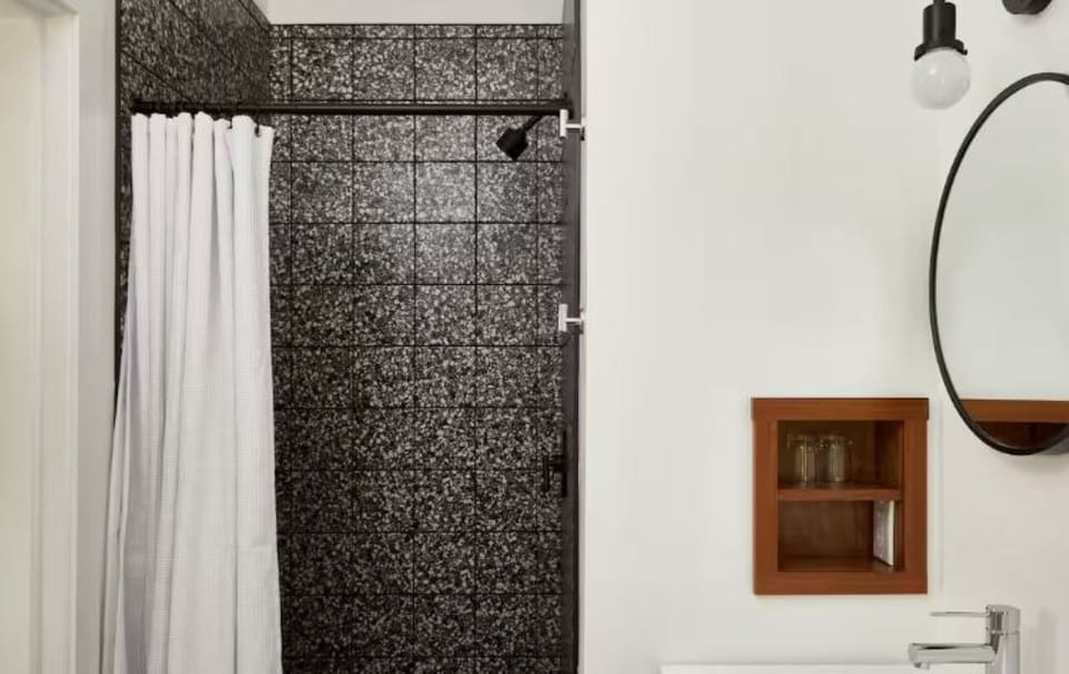 Refresh after adventures with a sleek shower and modern vanity.