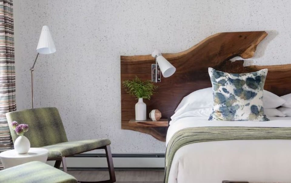 Sink into crisp sheets and warm wood accents for calm.