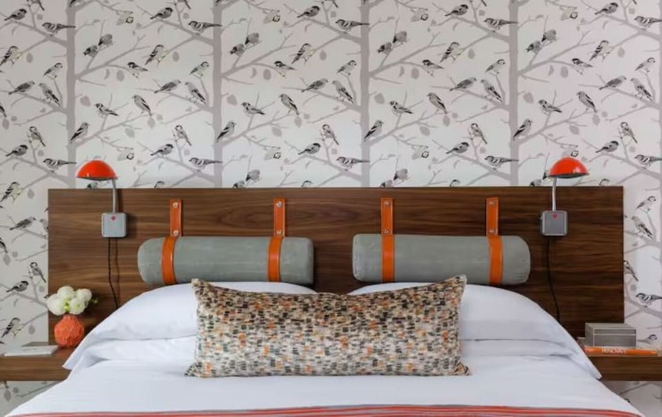 Sink into plush pillows beneath playful, boutique-style wall sconces.