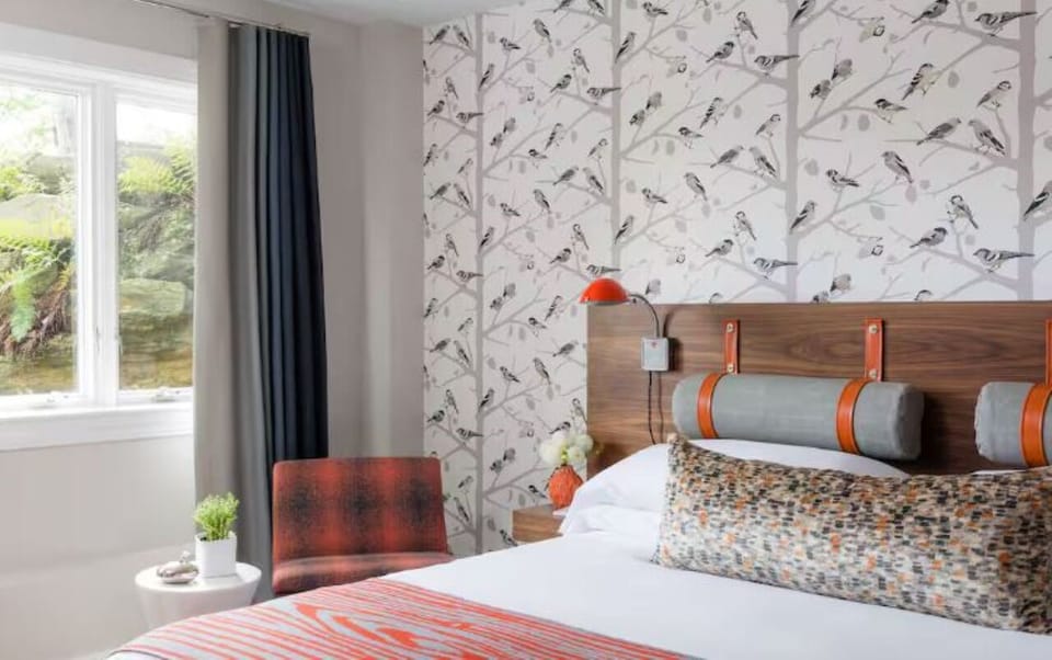 Sink into plush bedding in a bright, designer-styled room.