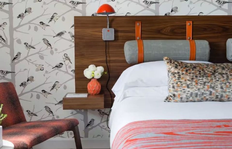 Wake up refreshed in a charming room with playful wallpaper.