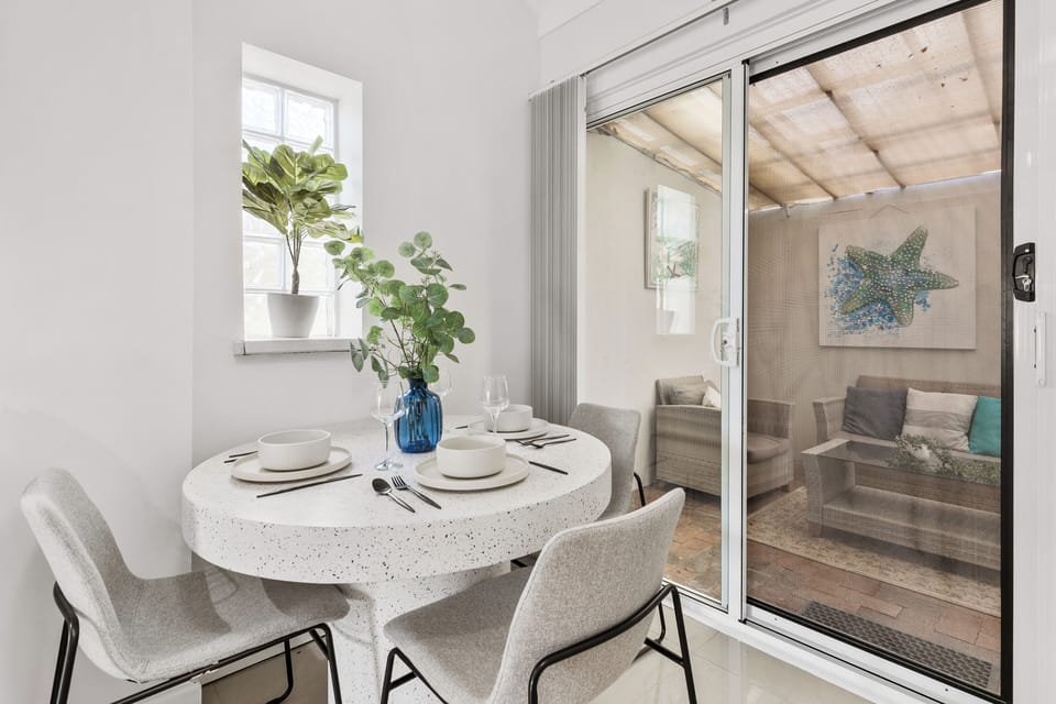 Dine in style! This chic dining nook features a trendy terrazzo table and plush seating for four, creating the perfect setting for a memorable meal. 