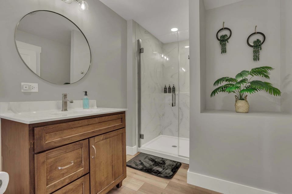 A spacious private bathroom featuring a modern walk-in shower.