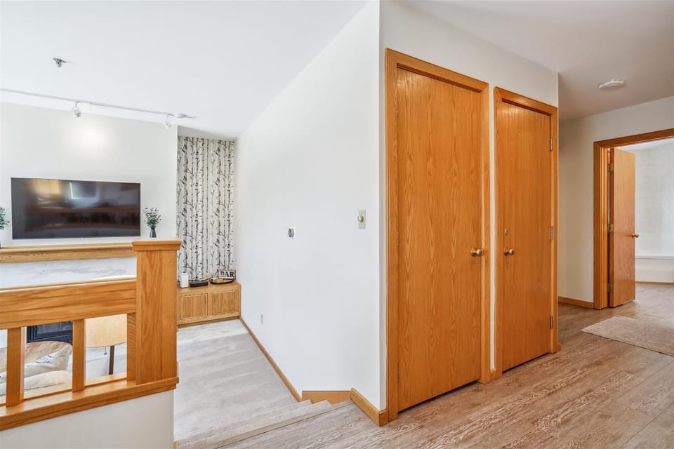 Simple entry hallway with hooks and storage space for coats and gear.