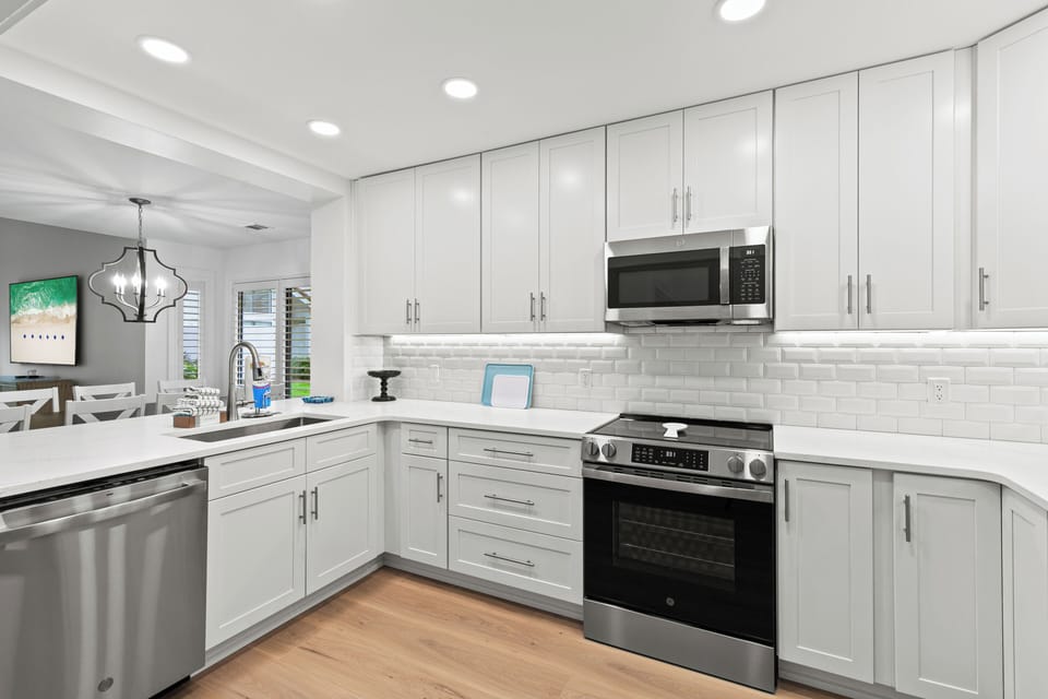 Kitchen with stainless steel appliances and to ceiling cabinets