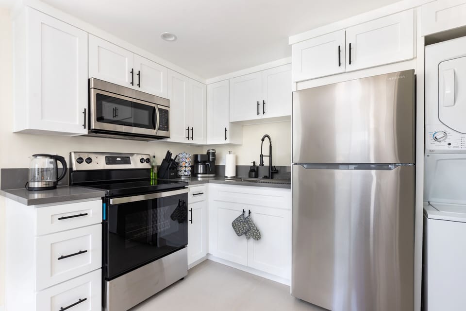 Clean kitchen with microwave and cooking essentials