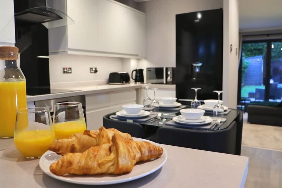 Dining Area: A modern dining space with seating for four, located next to the kitchen — perfect for enjoying meals, breakfast, or planning the day ahead.