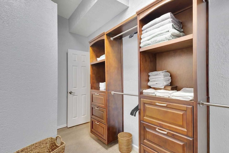 Primary closet stocked with plush linens, cozy blankets, and fresh bath towels.