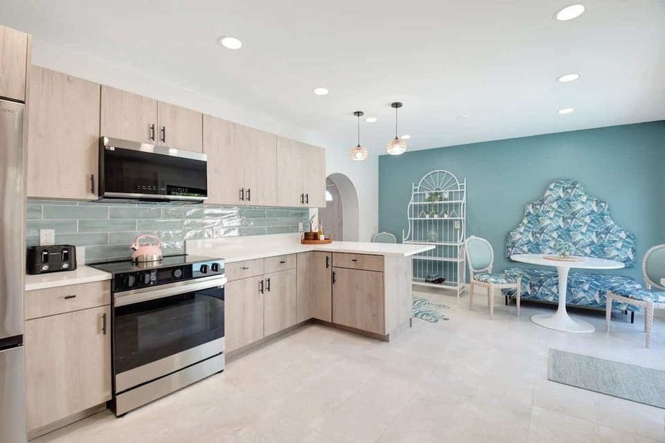 Vibrant kitchen entrance with sleek stainless steel appliances and eye-catching design.