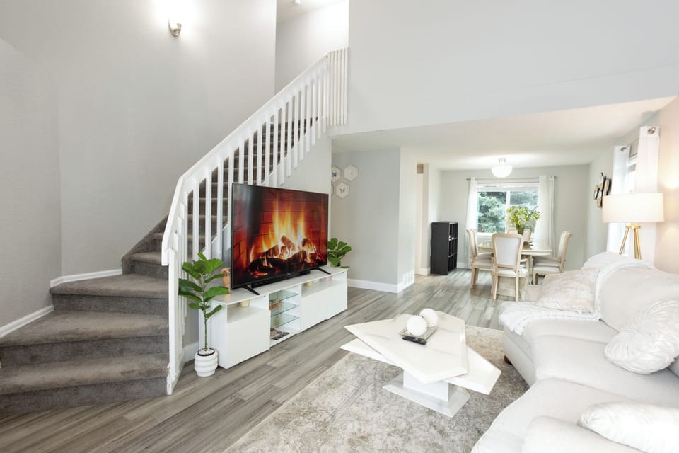 Living room with sofa bed (pull out couch) and 75 inch TV