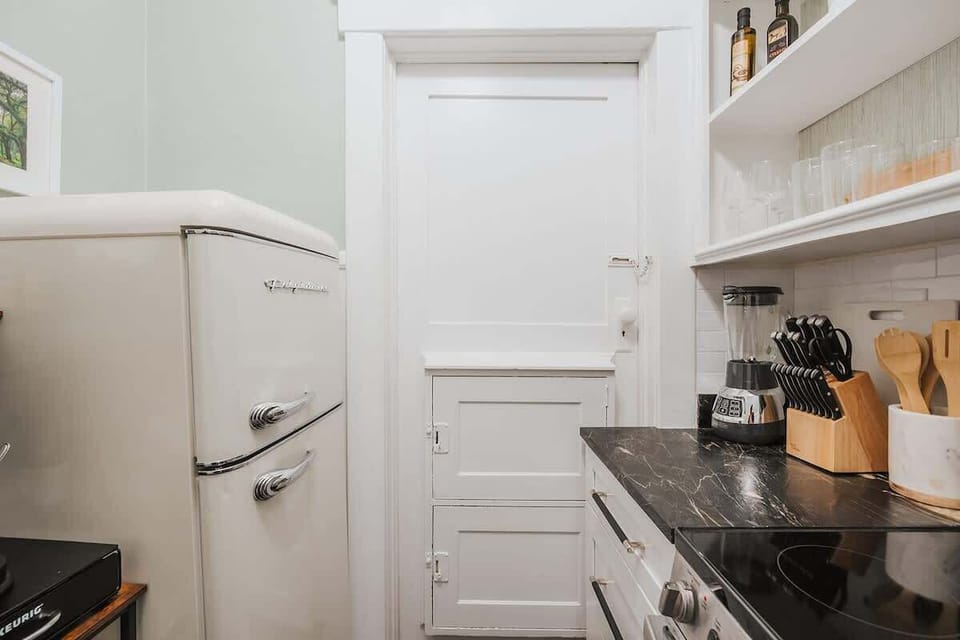 So much added charm to this retro kitchen! We love the historic milk doors.