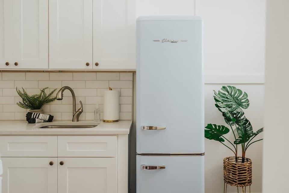 Enjoy a stunning updated kitchen with marble backsplash, brand new cabinets and a blue retro refrigerator. 