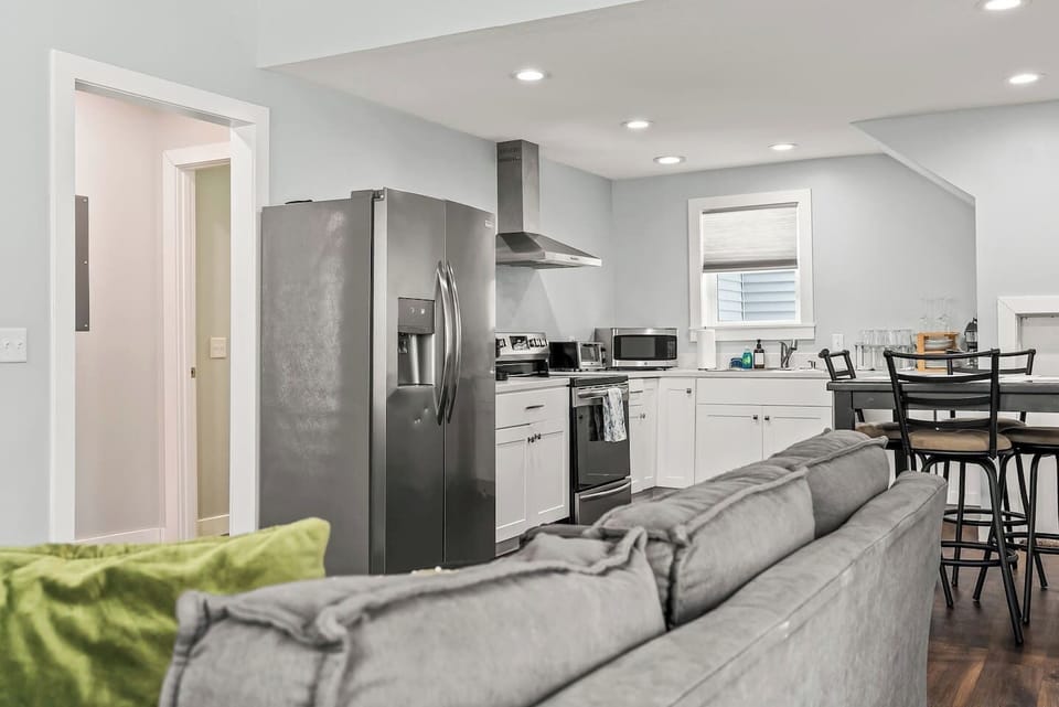 Open kitchen view from the living room showcasing stainless steel appliances, modern cabinetry, and an easy, open-concept layout.
