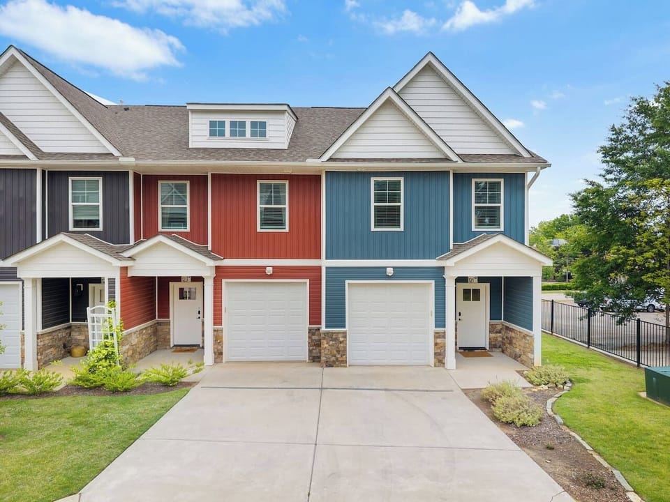 Welcome to your corner unit retreat! This crisp blue façade offers a stylish and private entry with garage parking included.