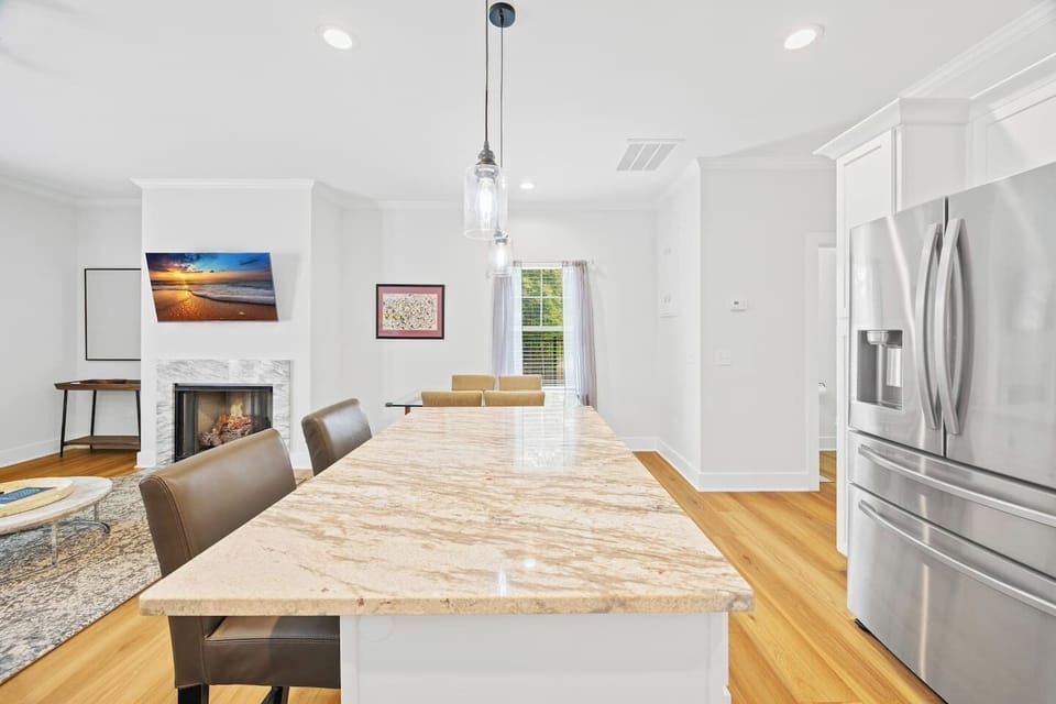 Pendant lights over the island add ambiance, while the functional layout makes cooking and hosting effortless.