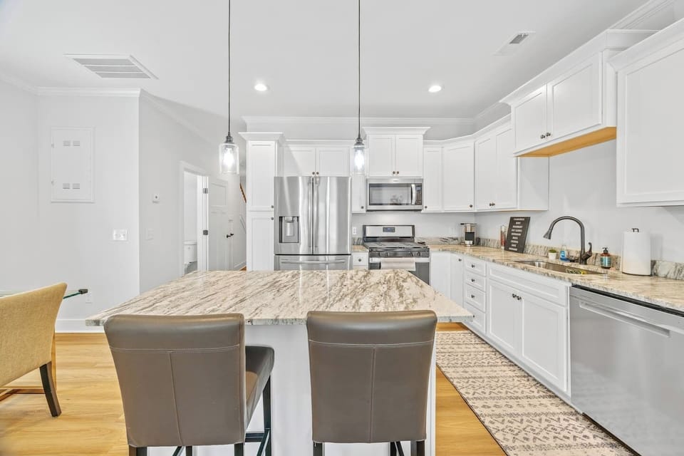A spacious granite island provides extra prep room and comfortable seating for casual meals or morning coffee.