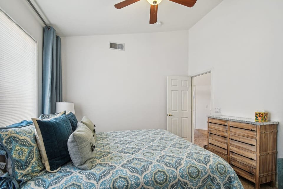 Unpack and unwind! Enjoy the comfort of a well-appointed space with plenty of storage, a ceiling fan, and chic bedside lamps for added ambiance.