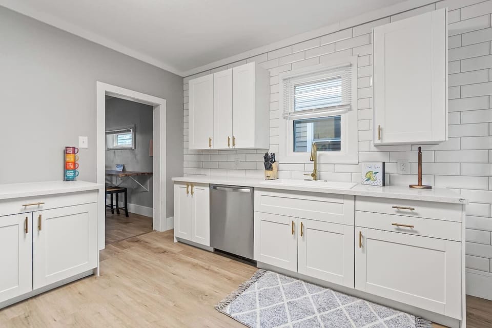 Spacious kitchen with ample cabinet storage and subway tile backsplash.