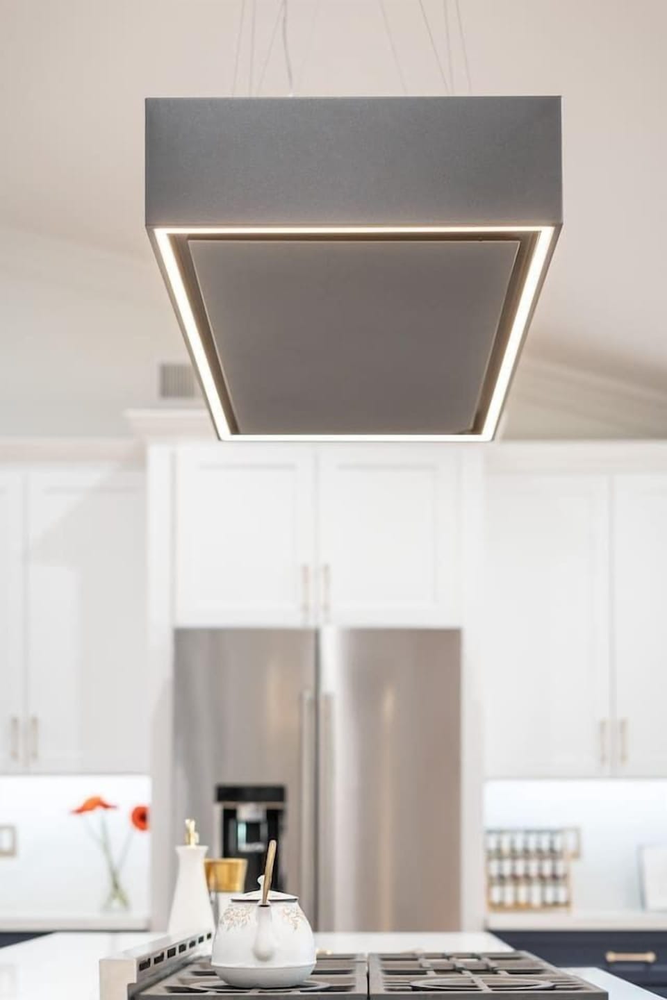 Even the lighting makes a statement. This modern pendant fixture adds the perfect blend of drama and elegance above the central island.