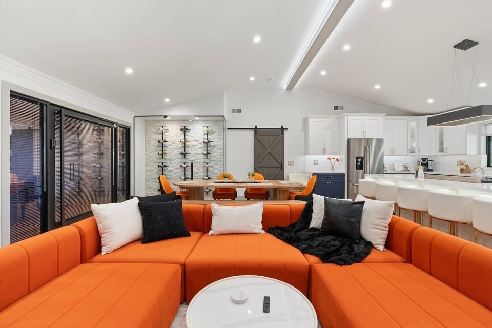 Host effortlessly in this open-concept space with designer seating, a show-stopping wine wall, and seamless flow from the living room to kitchen and dining.