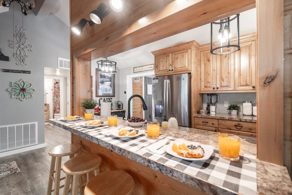 The heart of Roaming Buffalo—this warm, rustic kitchen and bar is perfect for gathering. Enjoy a fully stocked space, spacious seating, and cozy cabin charm that makes breakfasts, dinners, and memories come together with ease.