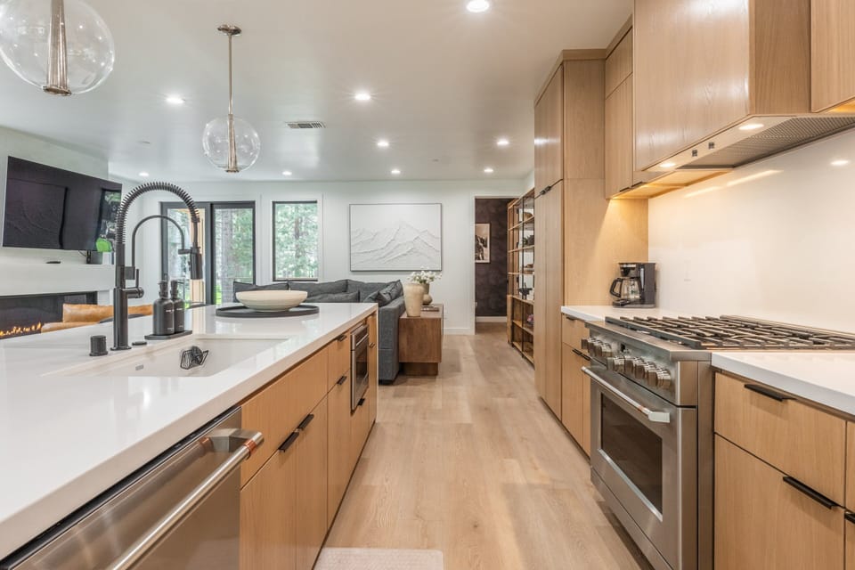 Fully Equipped Kitchen with Quartz Counters , Large Island, 5 Bar Stools, Cafe' Appliances, Fridge/Freezer and Separate Drink Fridge.
