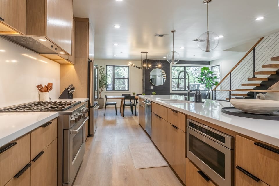 Fully Equipped Kitchen with Quartz Counters , Large Island, 5 Bar Stools, Cafe' Appliances, Fridge/Freezer and Separate Drink Fridge.