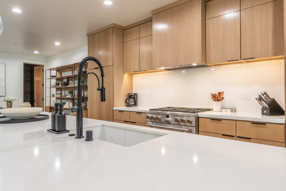 Fully Equipped Kitchen with Quartz Counters , Large Island, 5 Bar Stools, Cafe' Appliances, Fridge/Freezer and Separate Drink Fridge.
