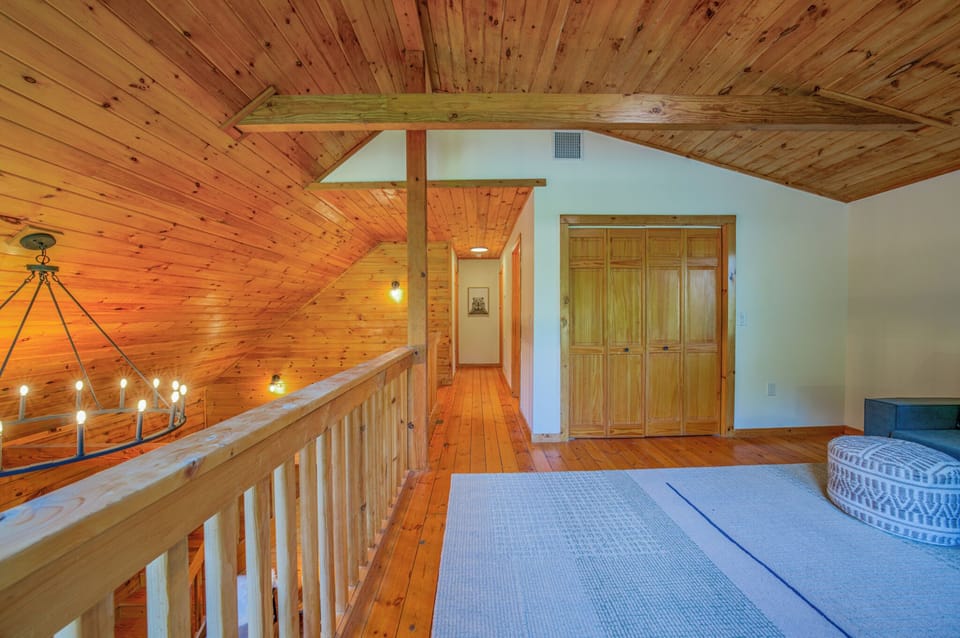 Upper-level loft with couch and dedicated workspace