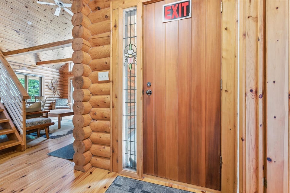 Welcome inside — warm log walls and natural wood tones greet you at Stonewood’s front entry.