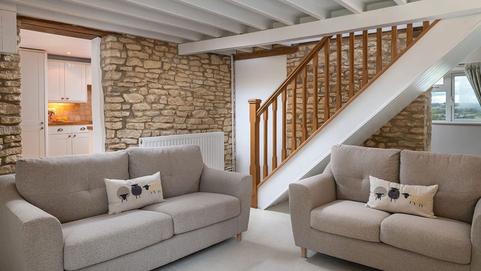 The exposed stone walls in the living room create a cosy feel
