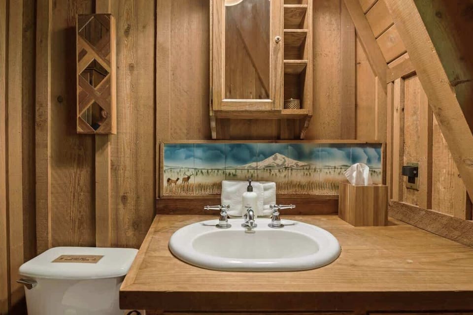 Refresh in your charming cabin bath right off the main livingroom! Rustic wood accents and thoughtful amenities make for a perfectly cozy start to your Cascadia Getaway.