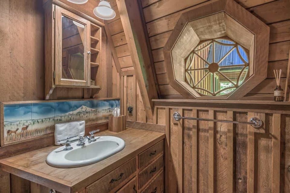 Refresh in rustic elegance! This charming bathroom right off the main living room with unique details offers a serene start to your forest adventures.
