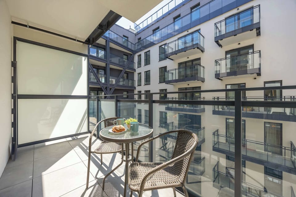 Spacious balcony with outdoor furniture.