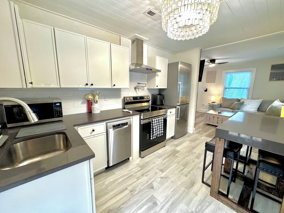 Although small, our well planned kitchen offers a fridge, dishwasher, range and a seating area.