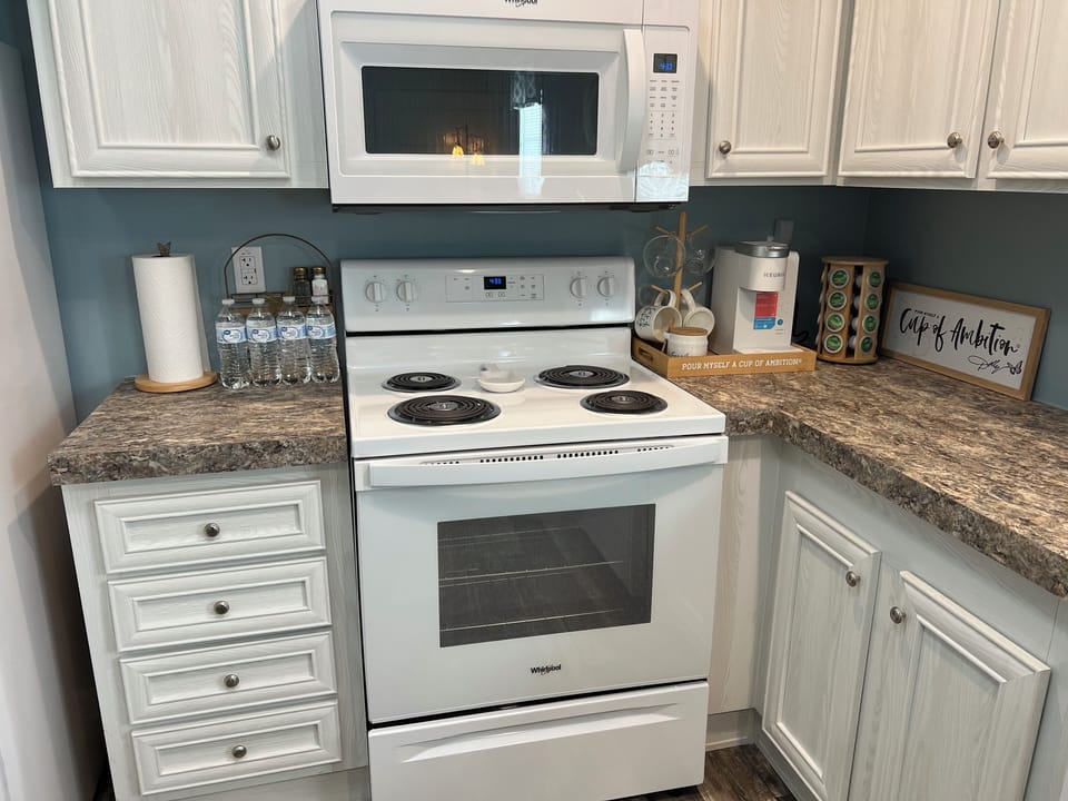 Cooktop stove/oven & microwave, & coffee station.