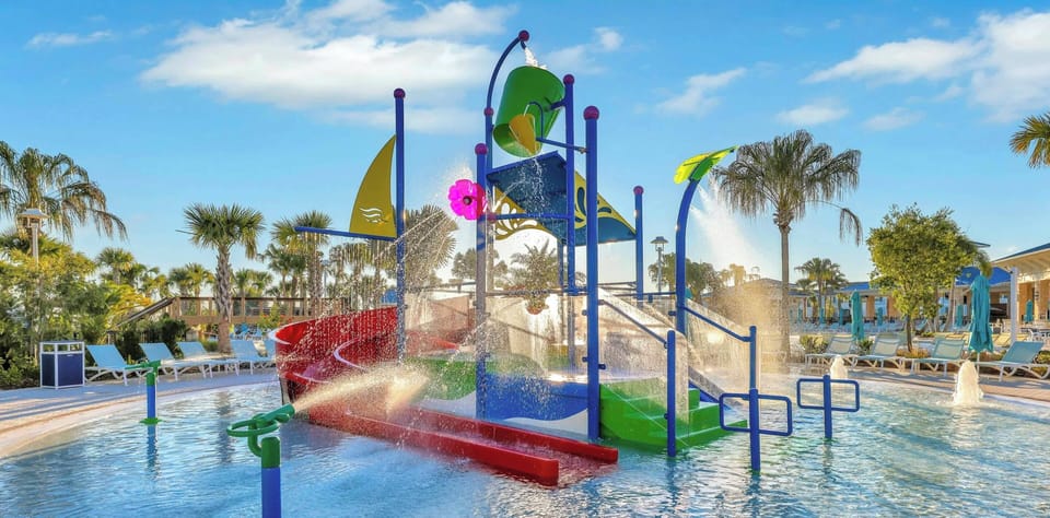 Enjoy endless fun in our colorful water play area, featuring exciting slides and engaging attractions. Surrounded by lush palms and sunny skies, this outdoor oasis is the perfect spot for families to relax and soak up the sun.