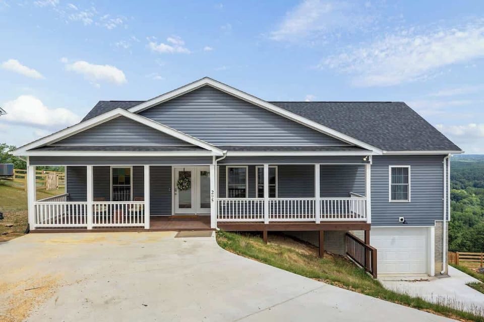 Mountainside ranch home with covered porch and paved drive