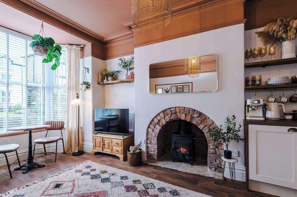 A beautiful, grand fireplace at the heart of the living space.