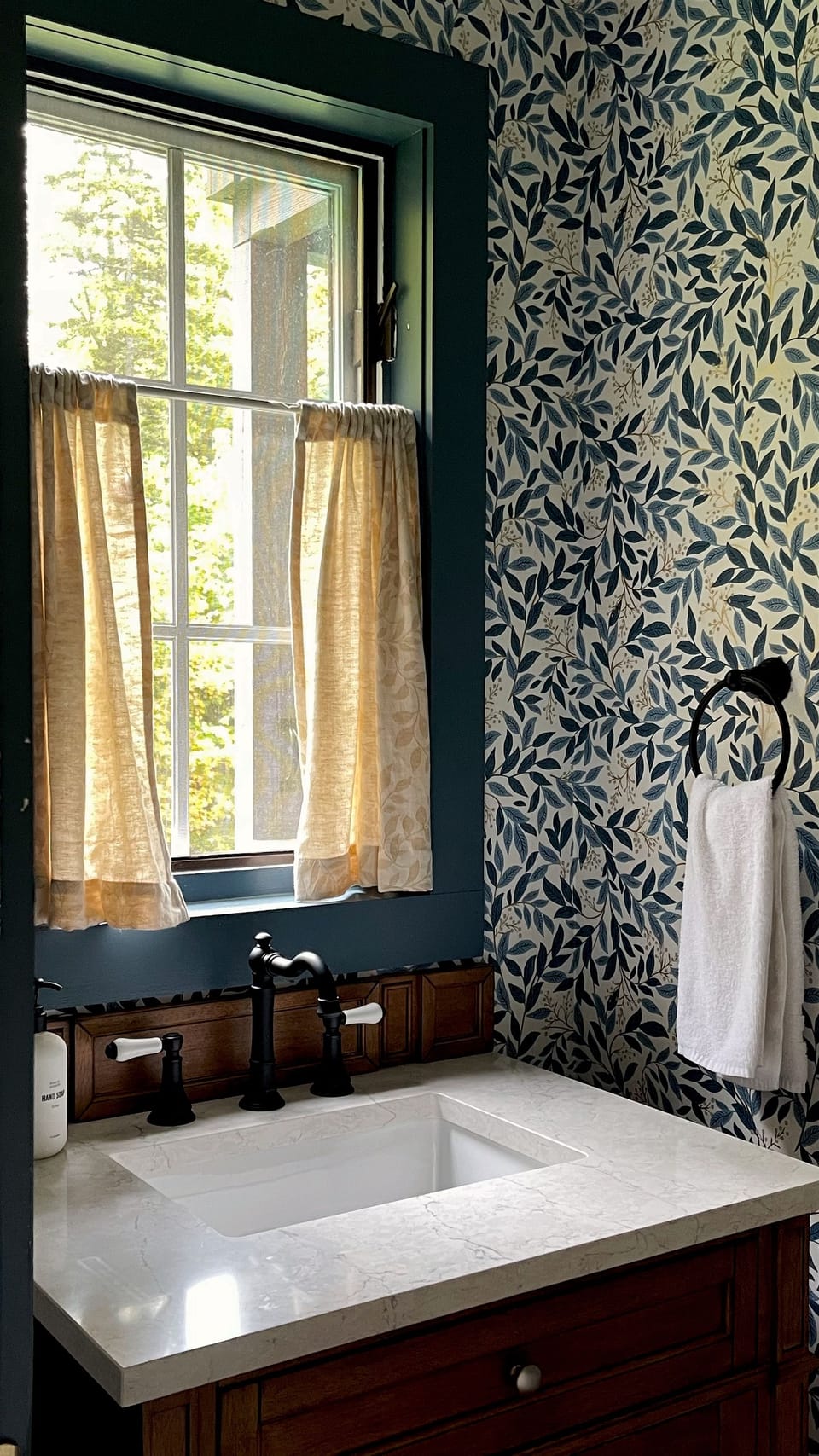 The powder room is cozy and functional. It is located off the office and provides convenience for when the Murphy bed is in use.