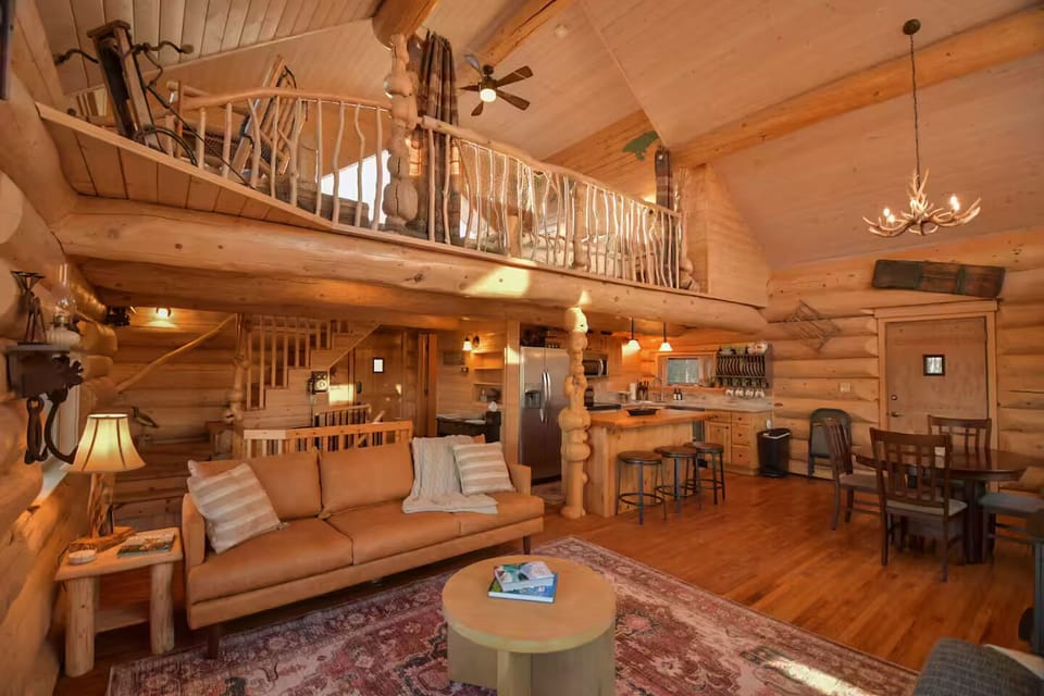 View of the loft, dining area and kitchen from fireplace.