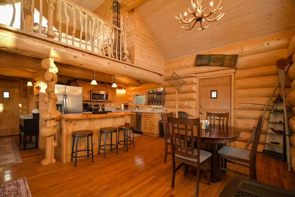 View of the dining area and kitchen from fireplace.