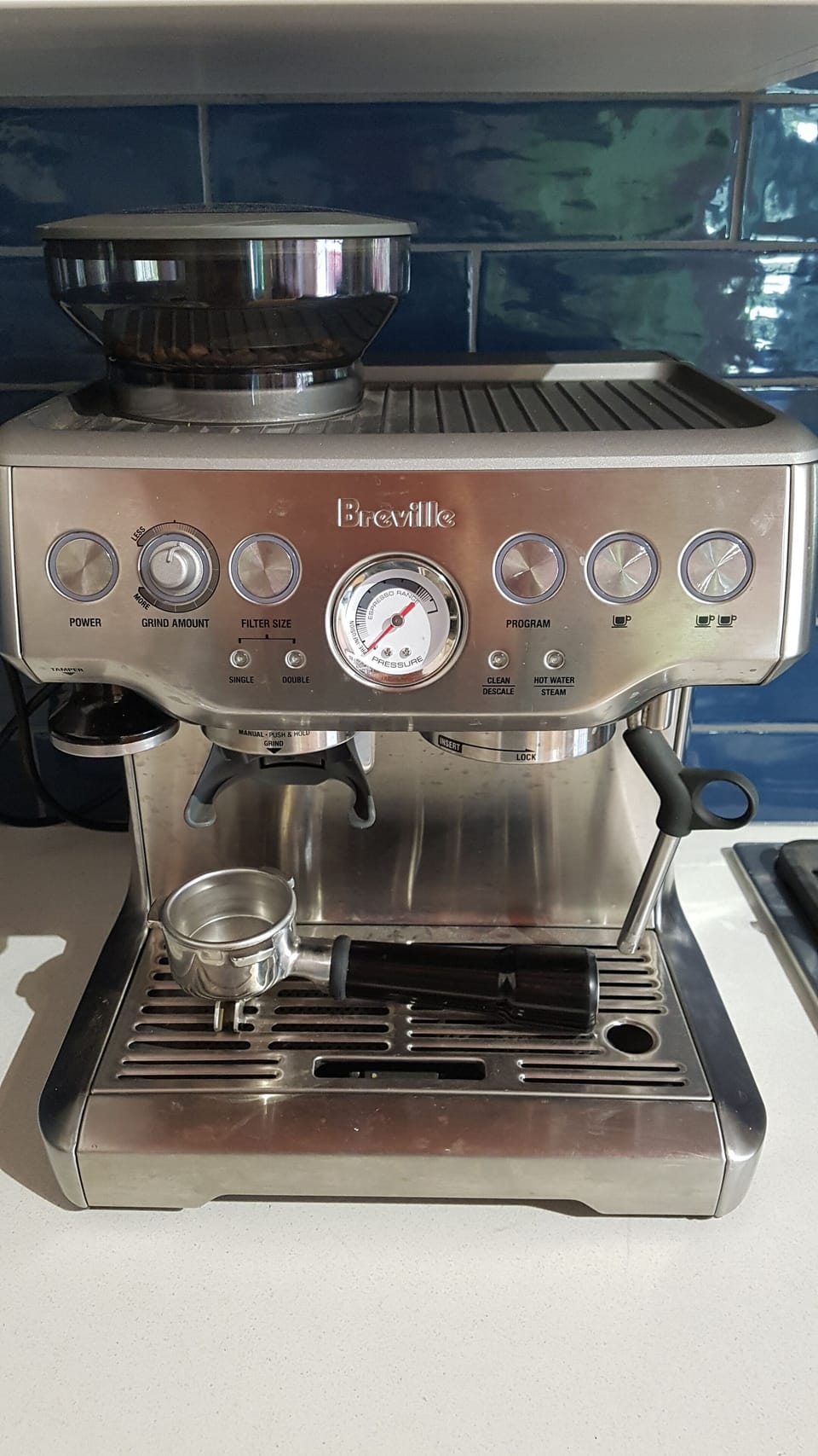 Esspresso machine and coffee beans provided.