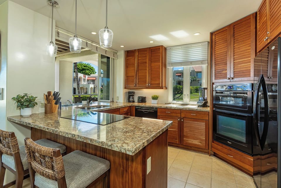 Large Kitchen w/Breakfast Bar and Passthrough Window to Lanai