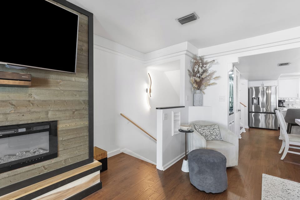 Cozy electric fireplace and large mounted TV on the second floor — perfect for relaxing nights in with the whole group.