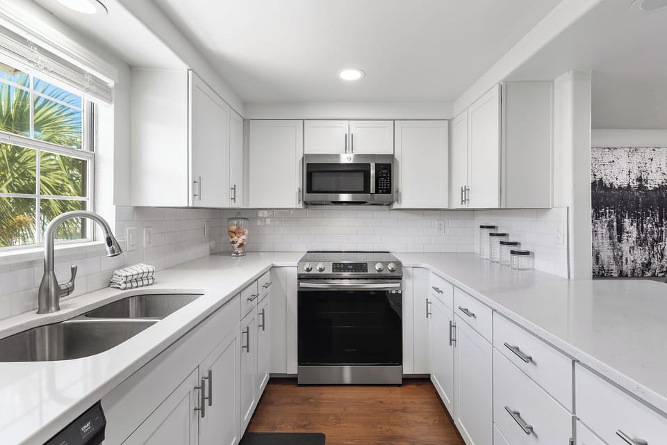 Newly remodeled kitchen that comes with a stove, microwave, dishwasher, and refrigerator.