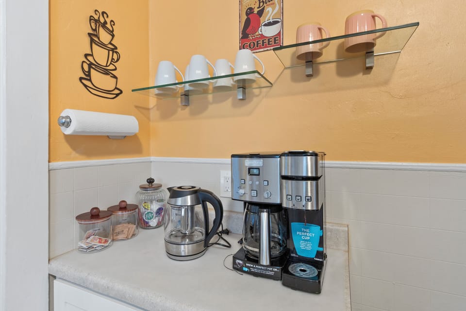 12 cup coffee maker or 1 K-cup. Electric water kettle. Sugars & creamer