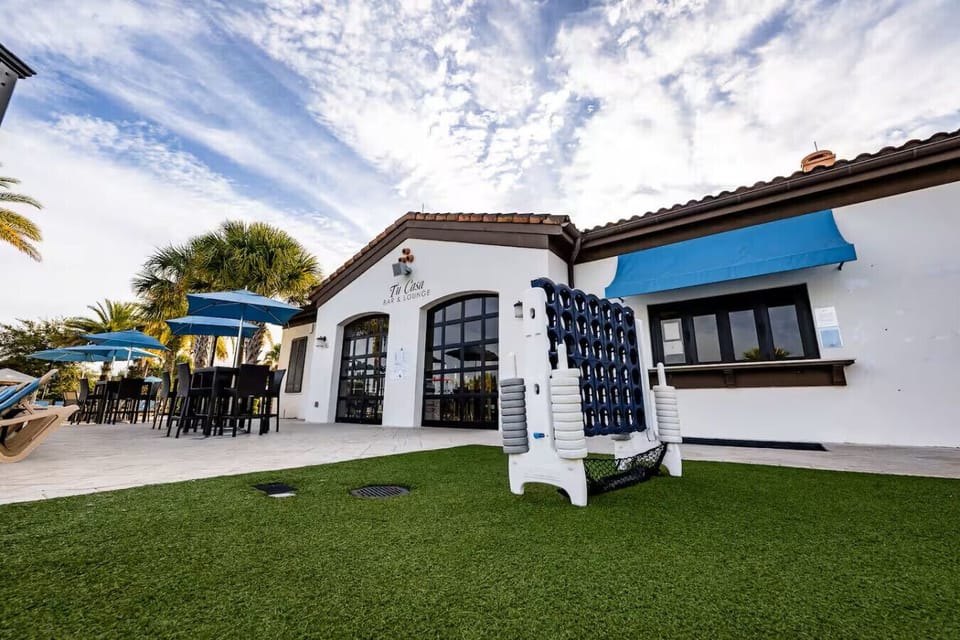 Fun outdoor patio with turf, dining space, and life-sized Connect Four.