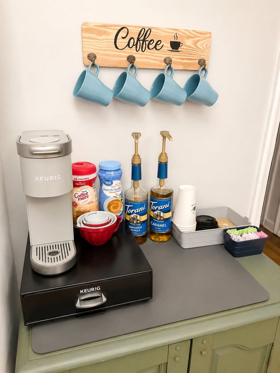 Complimentary coffee bar with Keurig, syrups, creamer, and tea