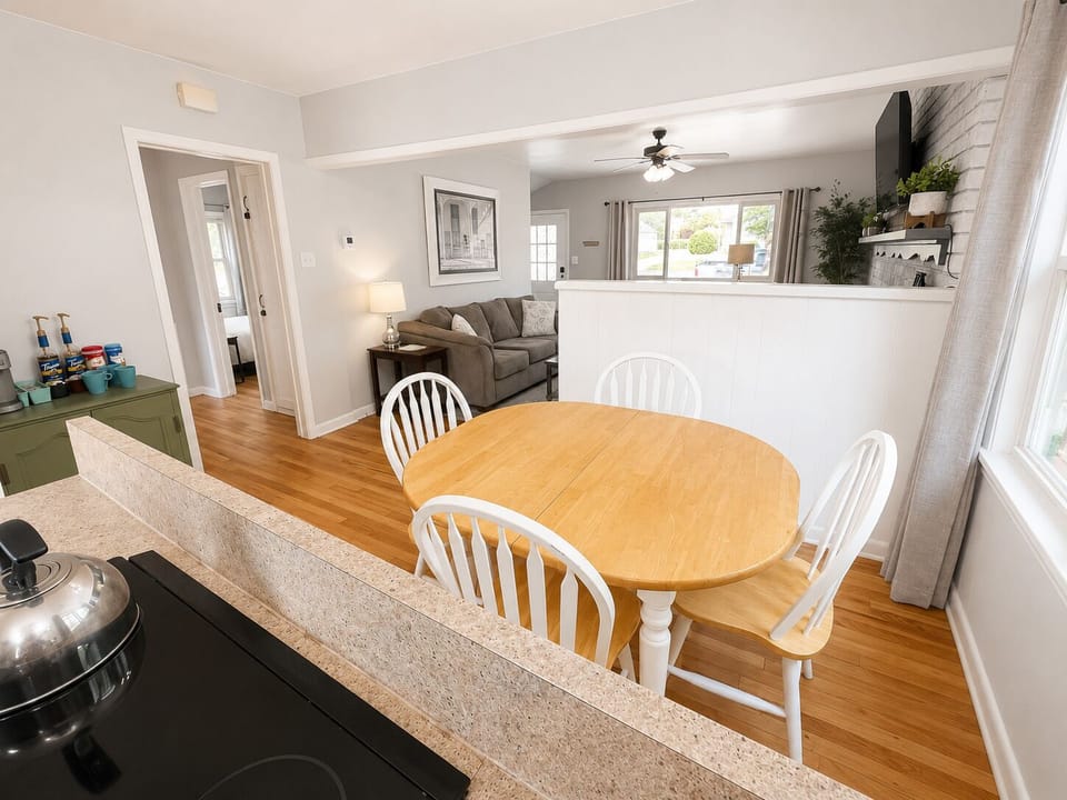 Open dining area with full kitchen, coffee bar, and cozy living room